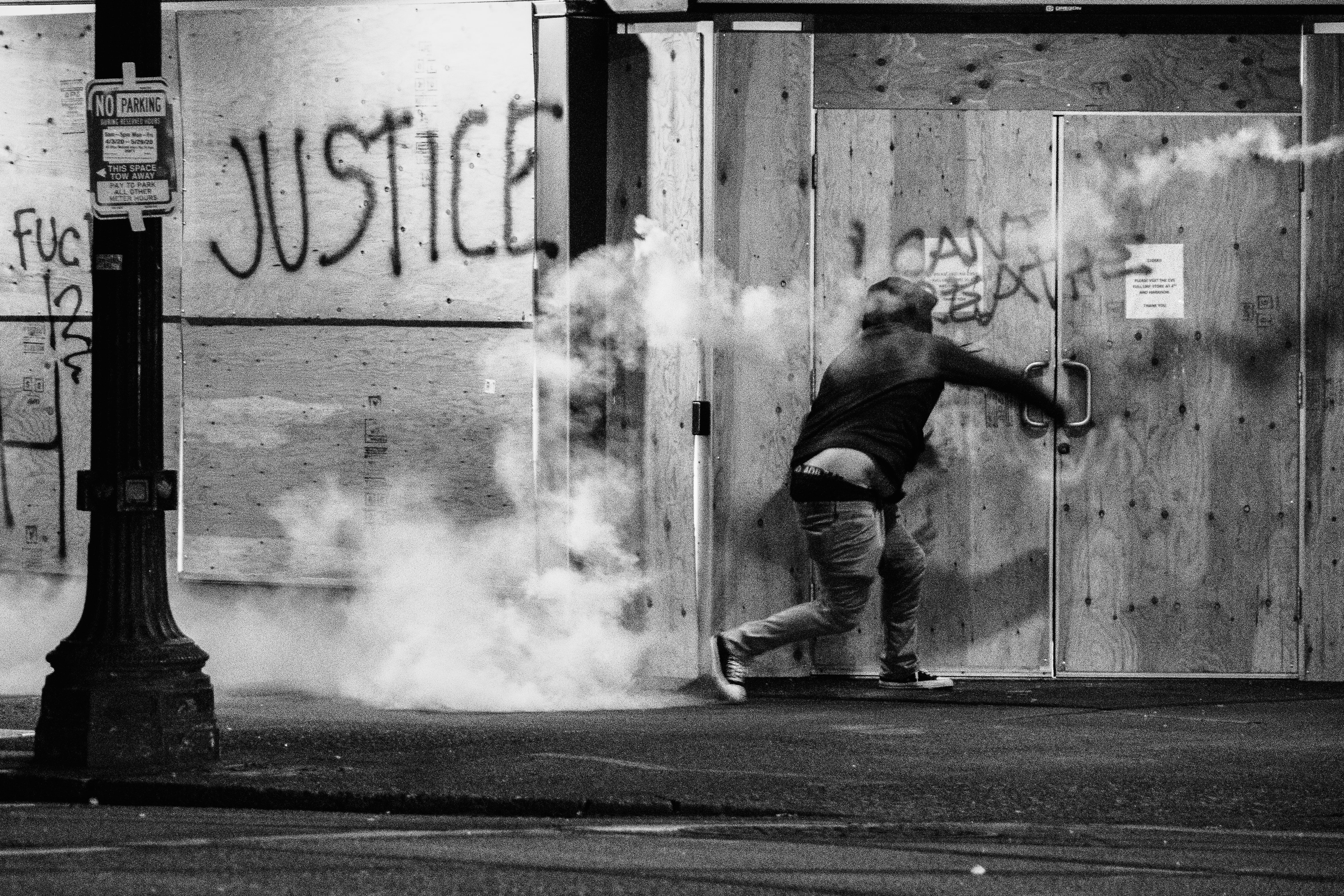 A protester throws a tear gas canister back at police during a Black Lives Matter protest in Portland, Oregon.